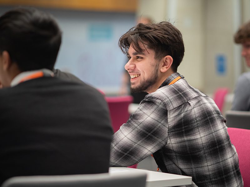 Young male student sitting in class