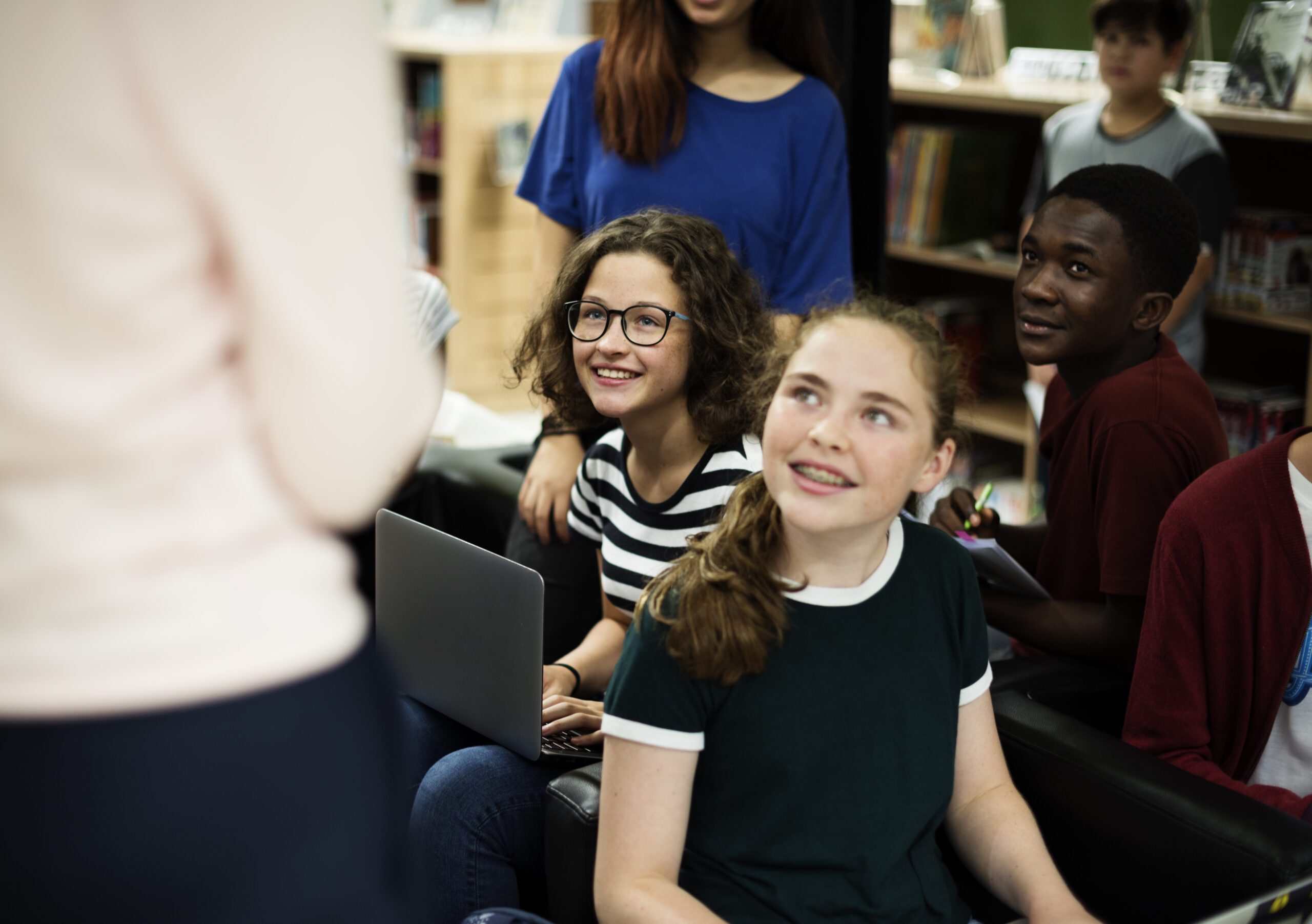 Group of diverse high school students studying in class